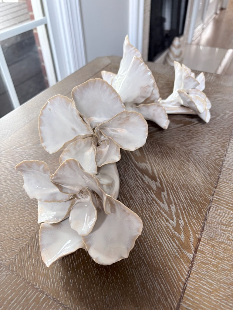 Handbuilt ceramic botanical sculpture in soft white and stone gray glaze with organic ruffled petal vine form