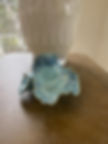 Handbuilt pottery trinket bowl in blue glaze with sculptural ruffled edges and organic marbled surface texture