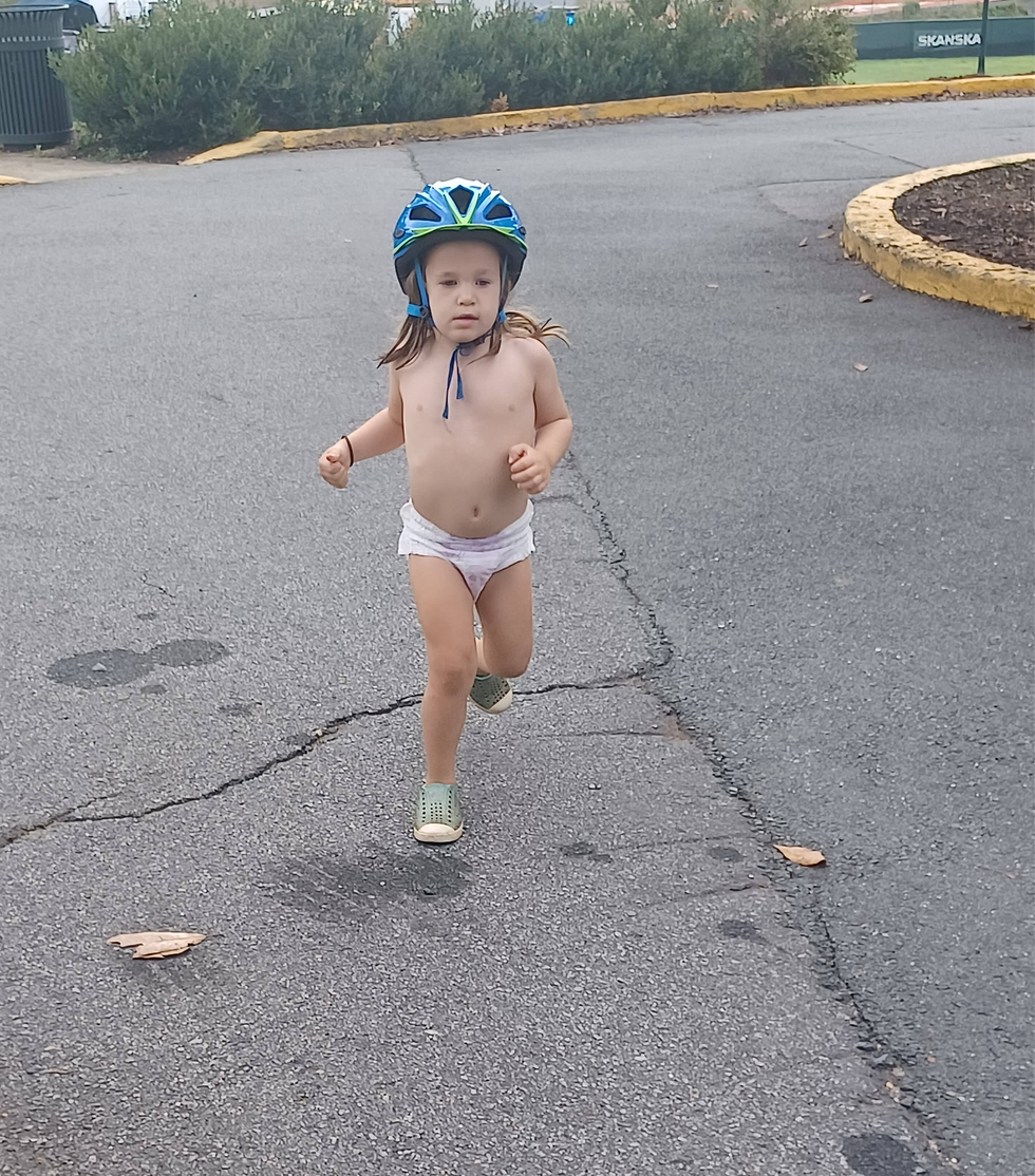 Josie running in underwear and a bike helmet