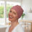 Thumbnail: A lady wearing pink chemo headwear for women with hair loss