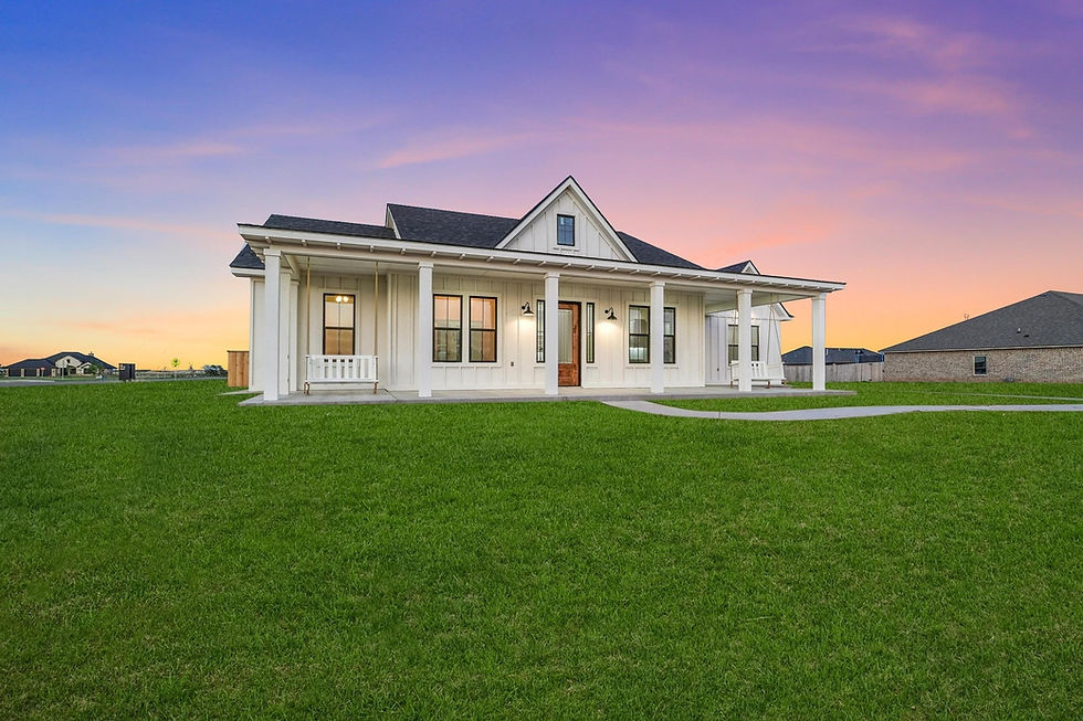 White modern farmhouse with covered porch at sunset by 111 Homes