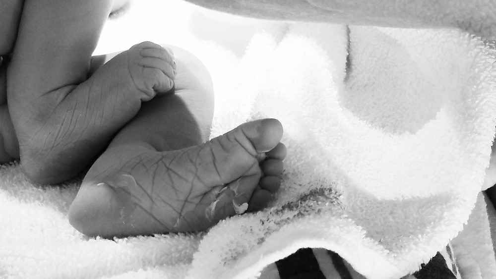 Brand new wrinkly baby feet.