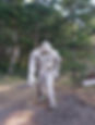big foot standing in forest that is made of driftwood