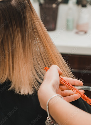 Close-up of hair trim on straight, blonde ombré hair