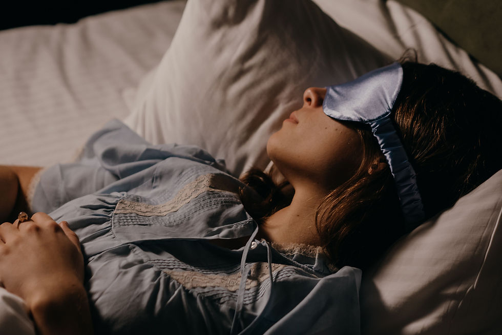 Woman sleeping peacefully in bed demonstrating healthy restorative sleep.