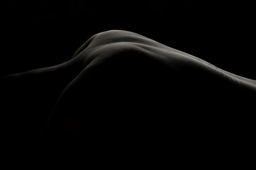 Artistic body photography with dramatic shadow and abstract composition in a California fine art studio