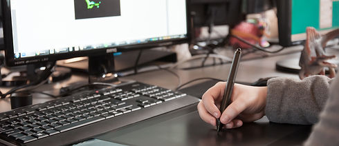 A hand holding a pen on a tablet