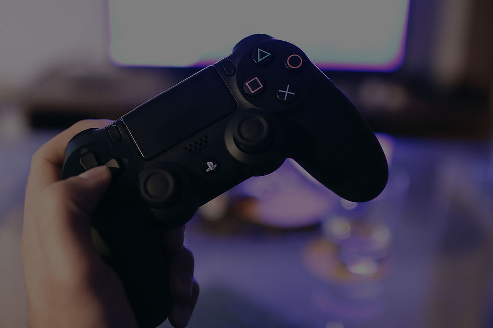 A hand holding a PlayStation DualShock Controller
