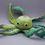 Thumbnail: Crochet soft toy octopus. In green mixed and white yarns.