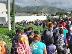 fila de migrantes