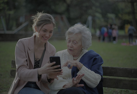 old woman with carer on bench