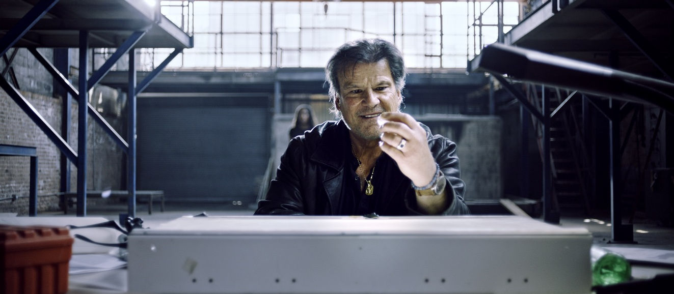 Jerome R Marzullo studying a crystal on an illuminated table. crime thriller investigation scene, Deep Chicago music video