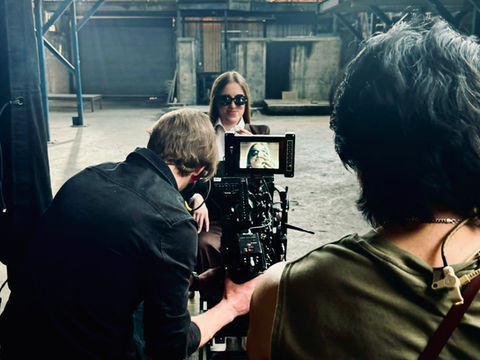 Gabriel Jung operating an ARRI Alexa 35 camera filming actress Camilla Alisetta in a Chicago industrial warehouse during the Deep music video shoot.