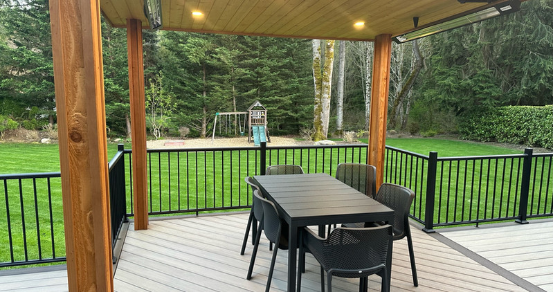 Beautiful custom backyard builds by Decks and Spas featuring deck and hot tub, privacy screen, BBQ centers, and firepits. Composite decking. Located in Redmond, Serving the Eastside, and Greater Seattle.