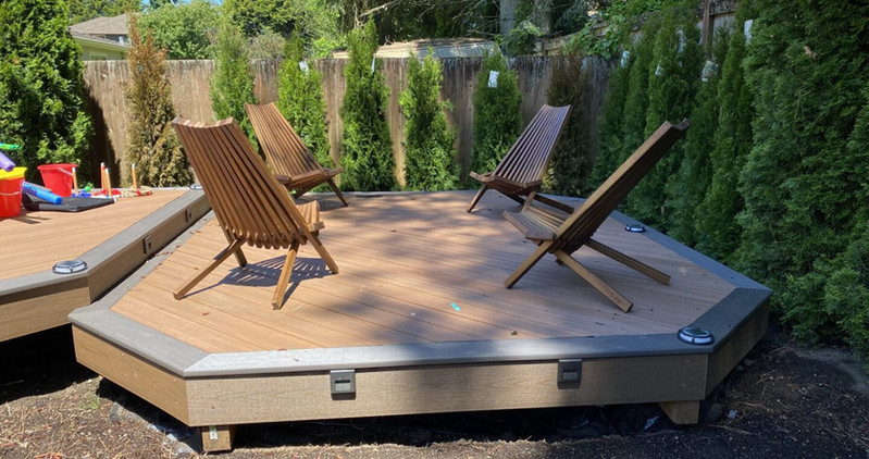 Beautiful custom backyard builds by Decks and Spas featuring deck and hot tub, privacy screen, BBQ centers, and firepits. Composite decking. Located in Redmond, Serving the Eastside, and Greater Seattle.