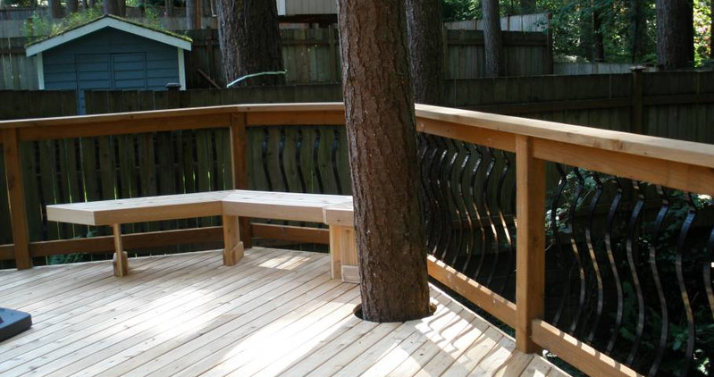 Beautiful custom backyard builds by Decks and Spas featuring deck and hot tub, privacy screen, BBQ centers, and firepits. Composite decking. Located in Redmond, Serving the Eastside, and Greater Seattle.