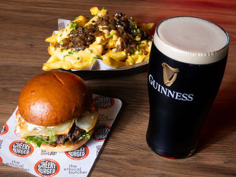 burger, chips and Guinness on a table