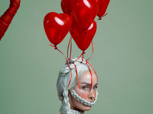 red heart balloons above a lady
