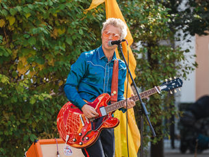 a man singing and playing the guitar