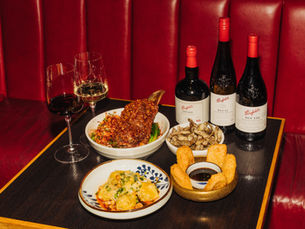 Chinese food on a table with wine