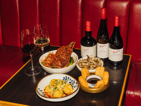 Chinese food on a table with wine