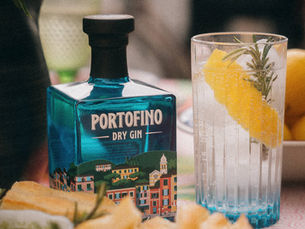 a bottle of gin next to a drink on a table