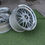 Thumbnail: Silver BBS wheels on grass. Shiny rims with the BBS logo present. wheels B and B
