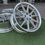 Thumbnail: Shiny silver alloy wheels displayed on green grass. wheels B and B