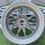 Thumbnail: Close-up photo of a metallic car wheel with B and B wheels.