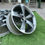 Thumbnail: Close-up view of grey alloy wheels on fake grass background, wheels B and B.