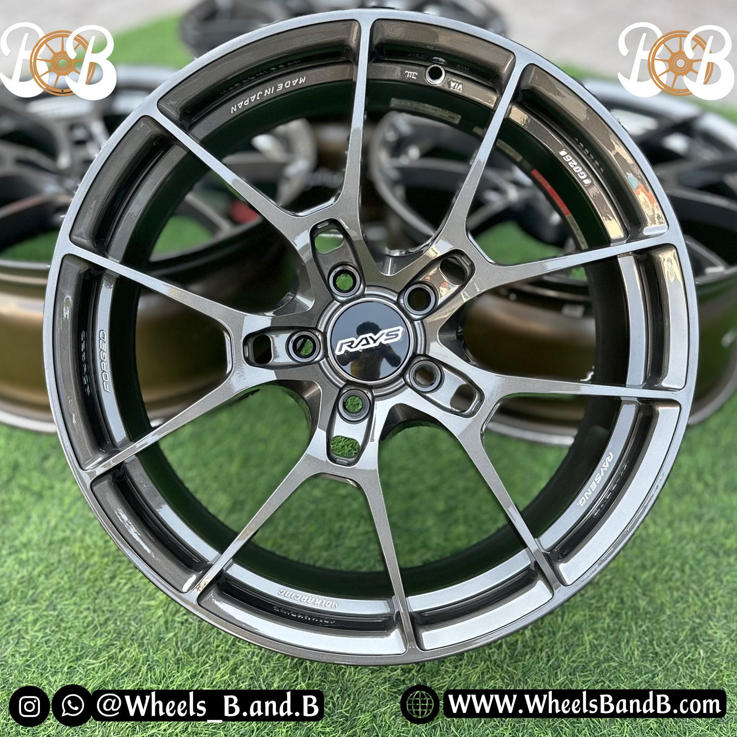 Close-up shot of a silver wheel with text Wheels B and B, wheels B and B.