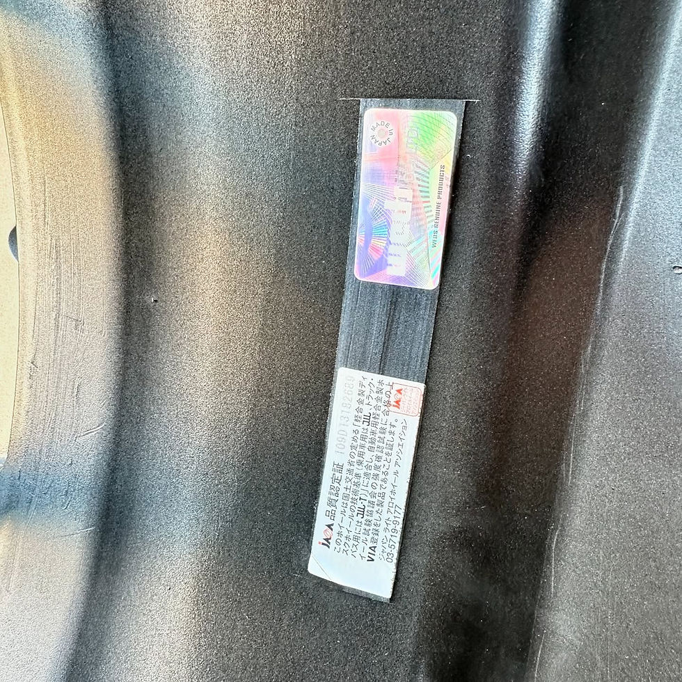 الصورة المصغرة: Close up of a sticker with text on a black surface.