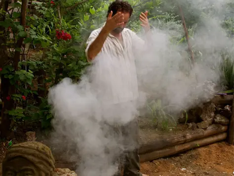 Preparation for a sacred ceremony - bathing in Palo Santo smoke