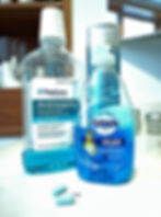 Blue mouthwash, shampoo, dish soap and pills