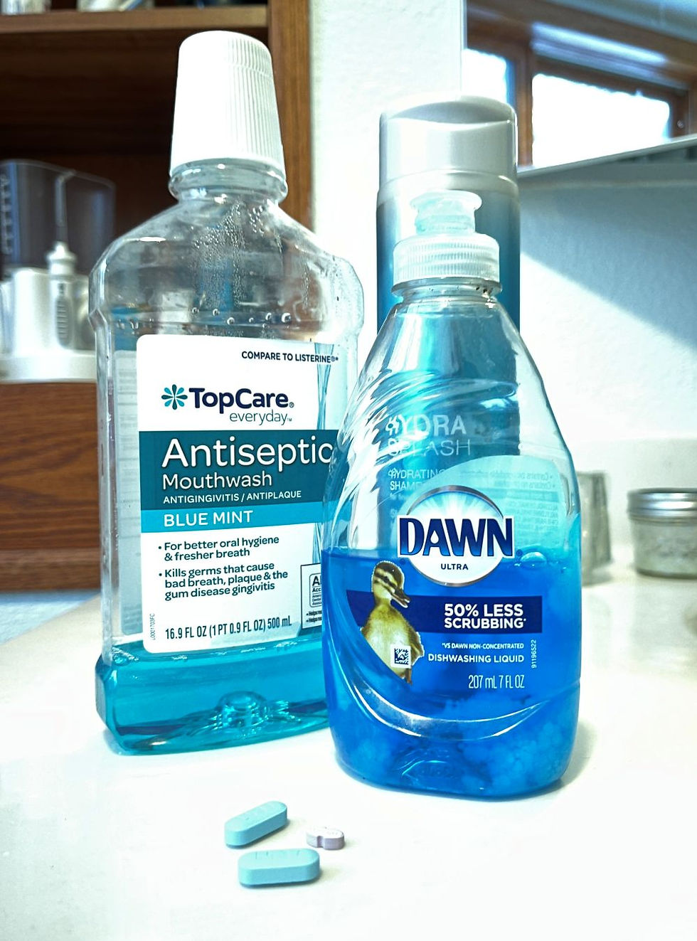 Blue mouthwash, shampoo, dish soap and pills