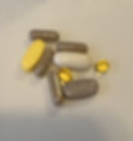 Photo of beige, yellow and brown capsule, pills, and tablets.