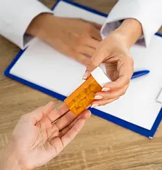 high-angle-people-holding-pills.webp