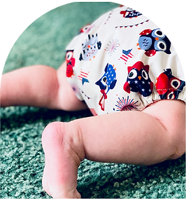 A crawling baby wearing a nappy.
