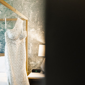 Dress hanging on bed.