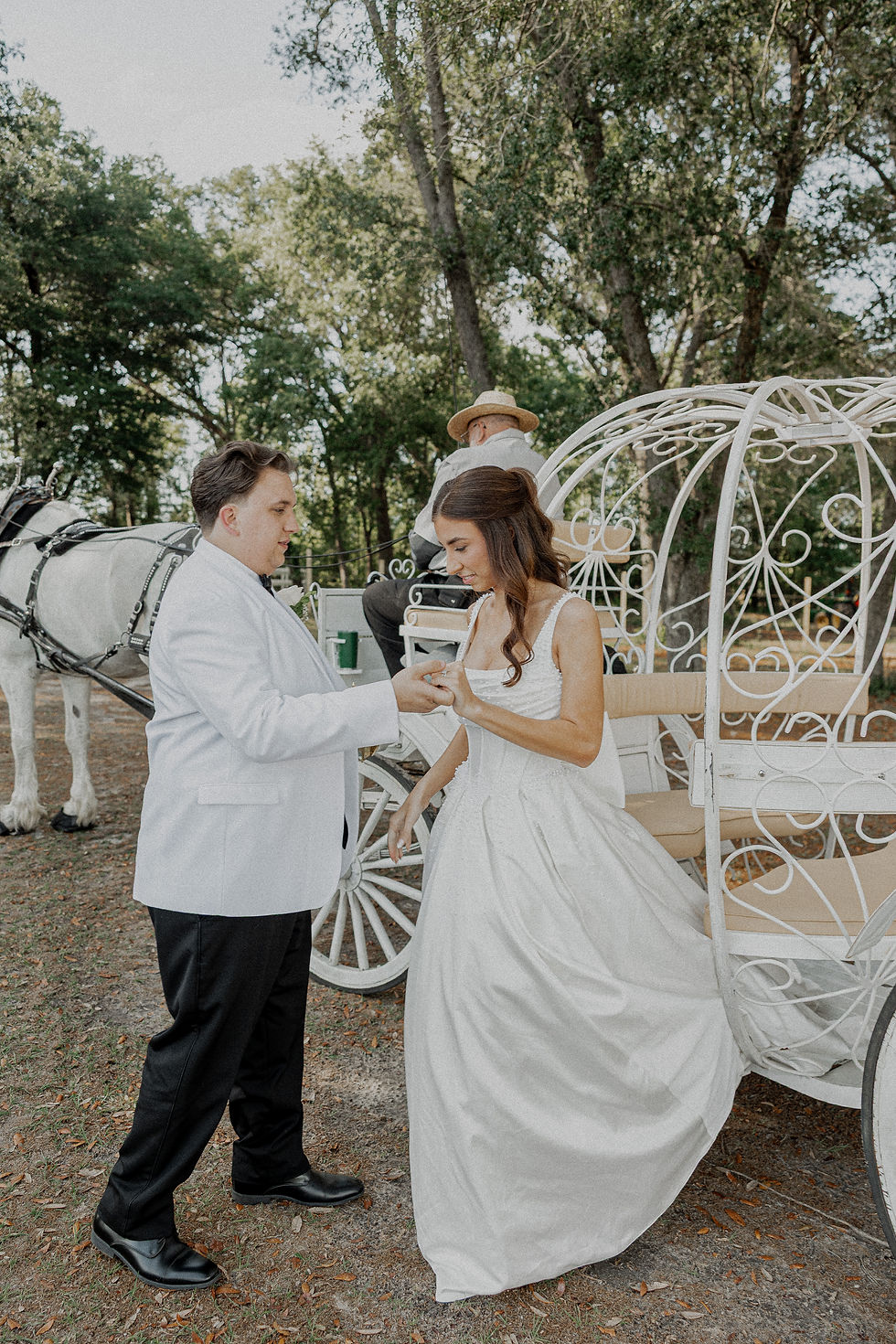 Bride and groom getting out of horse and carriage