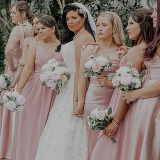 Bride posing with bridesmaids