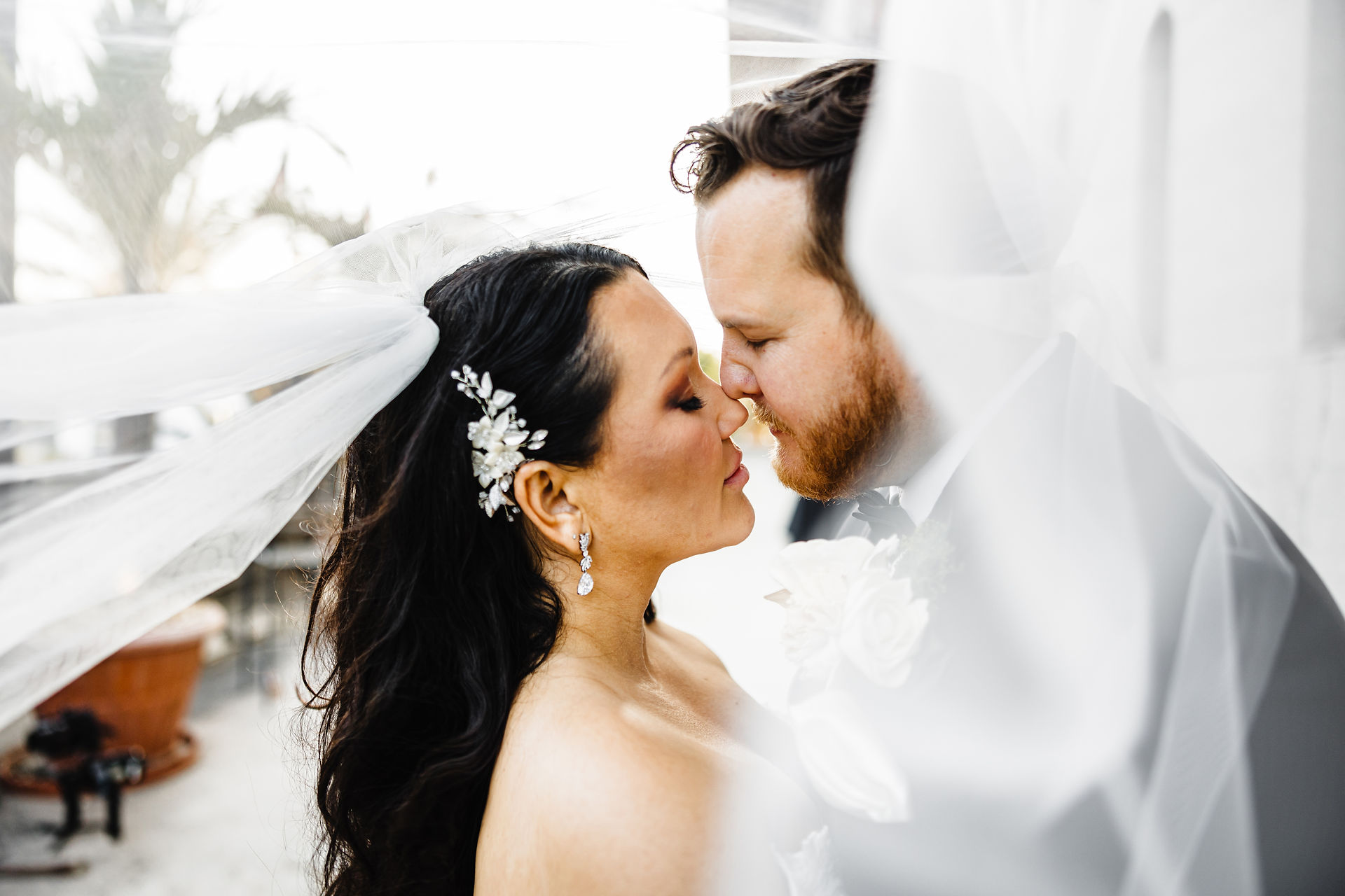 Bride and groom under veil