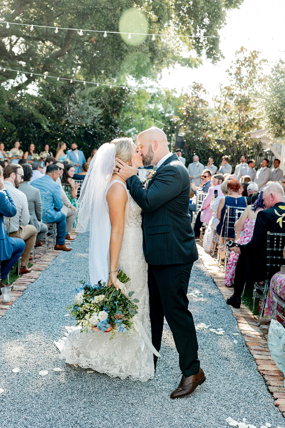 Bride and groom kissing during the ceremony.