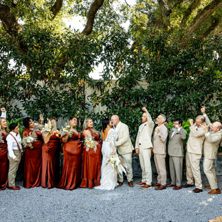 bride and groom standing with bridal party.