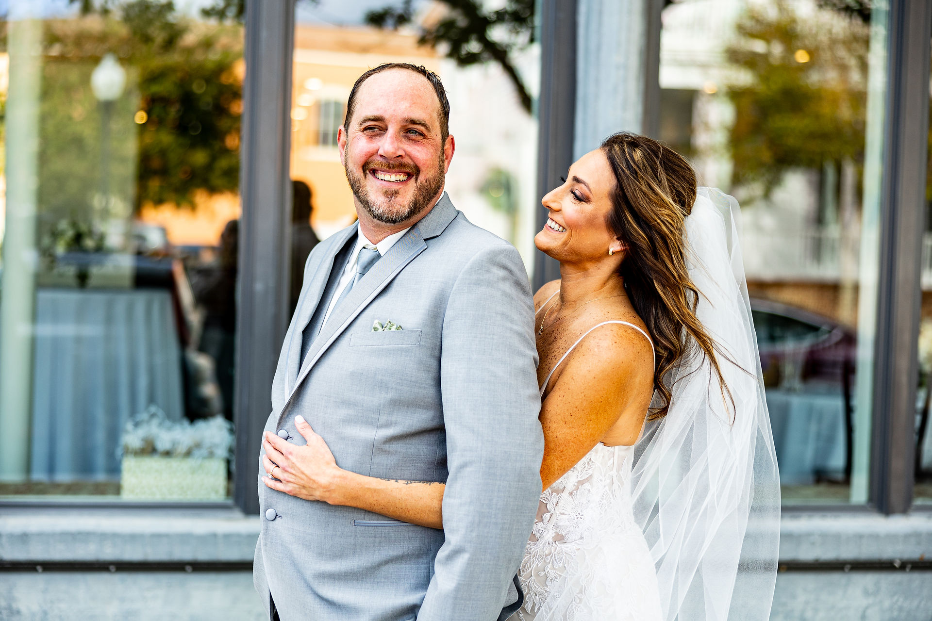 Bride hugging groom.