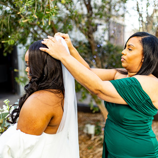 Mother of the bride putting veil in.