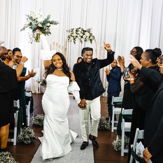 Bride and groom cheering down the aisle.