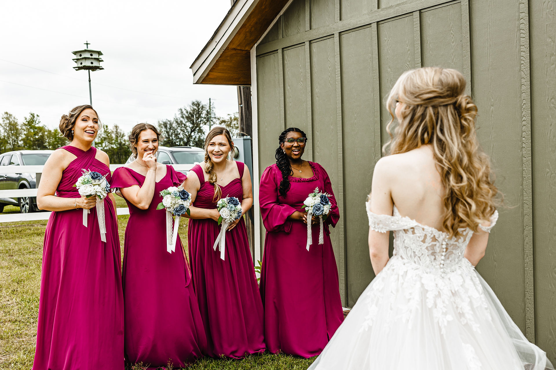 Bridesmaids looking at bride on wedding day.