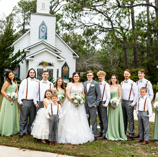 Bride and groom posing with bridal party.