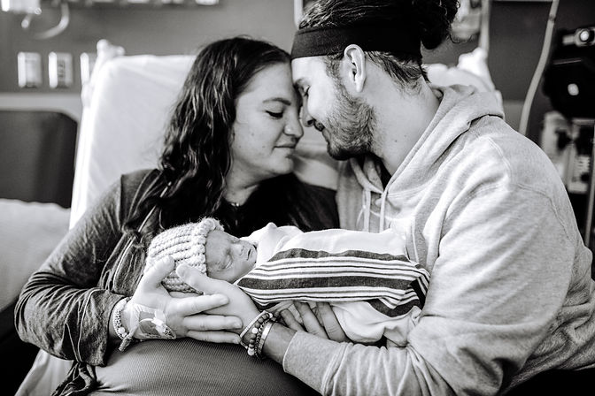 Owner and Graphic Designer of Da Enzo and wife holding baby